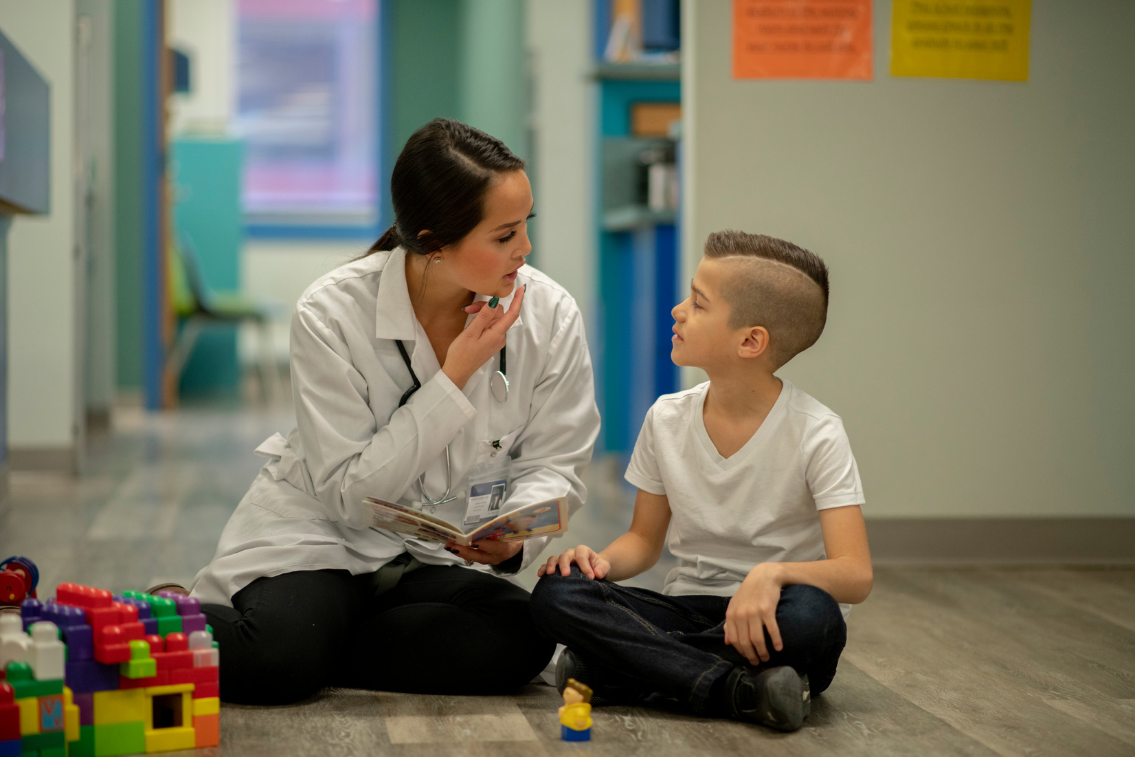 Speech therapist sitting with a child