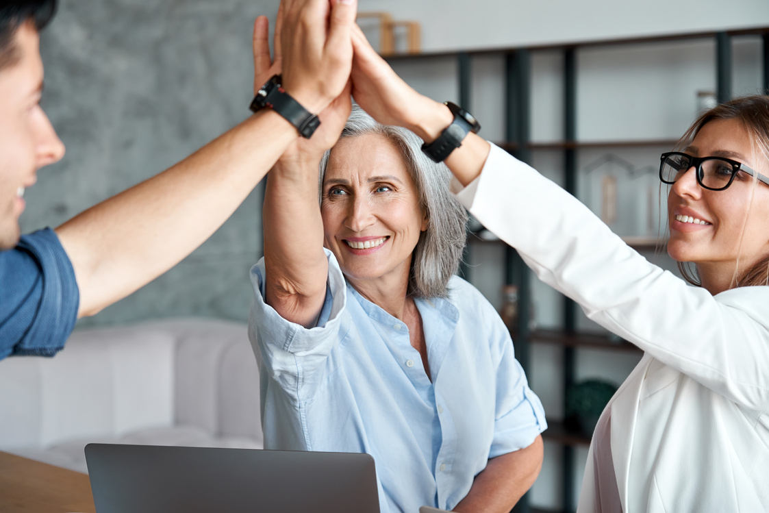 Mentor High-Fiving with Young Employees 